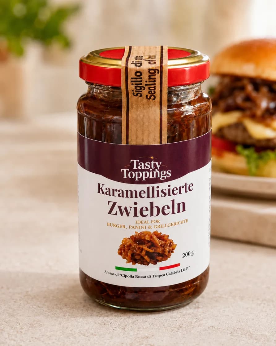Glas Tasty Toppings karamellisierte Zwiebeln, im Hintergrund ein Burger